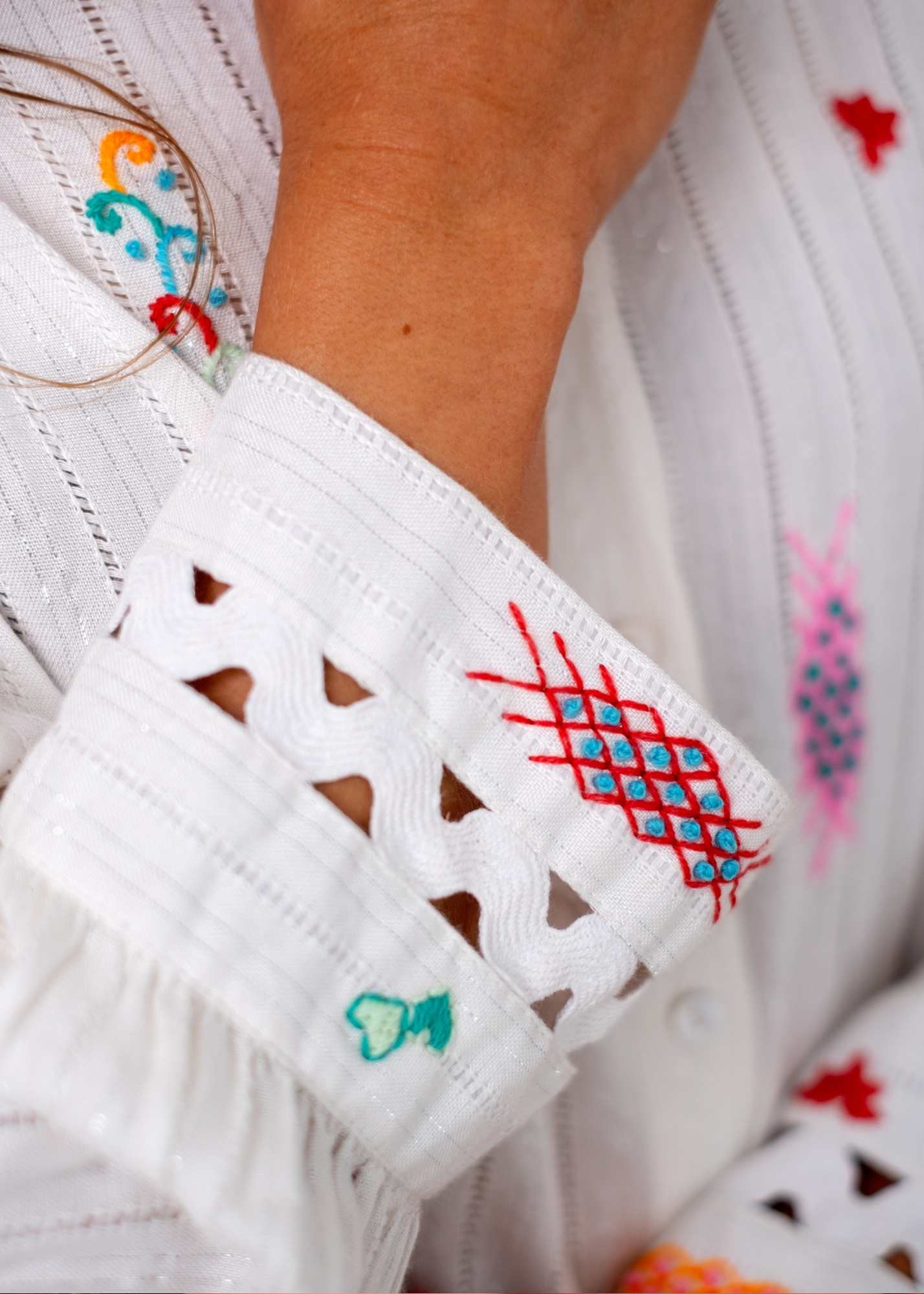 The Lily  Button-Down Shirt in White with Colourful Embroidery and Cut out Cuff Detail